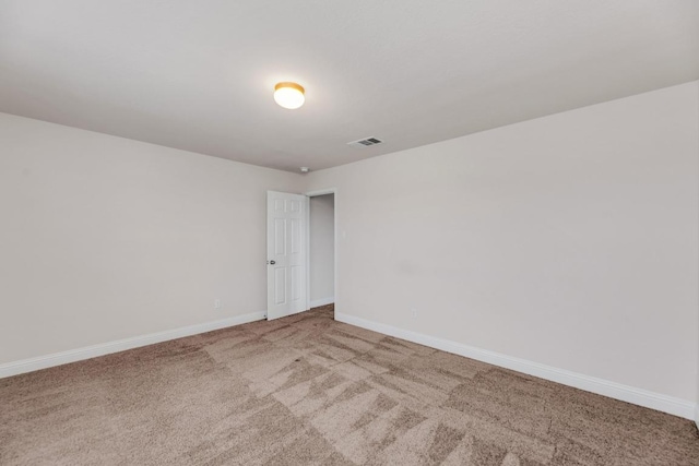 spare room with carpet and baseboards