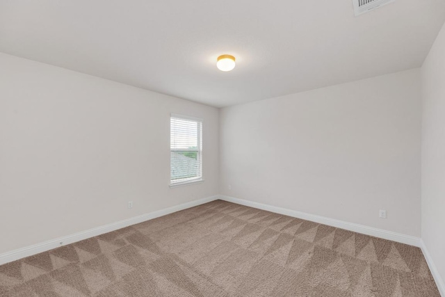 unfurnished room featuring carpet flooring and baseboards