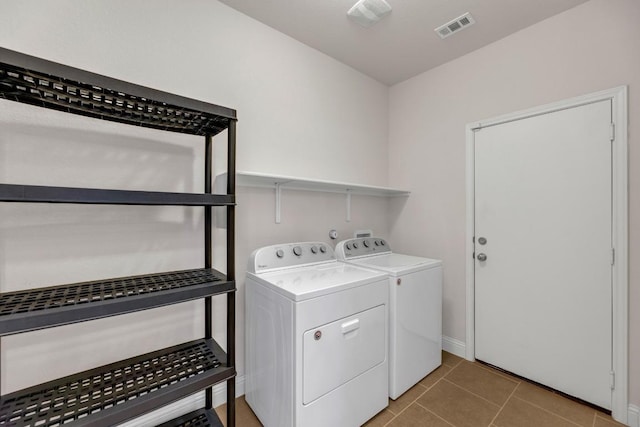 laundry room with laundry area, visible vents, baseboards, independent washer and dryer, and light tile patterned flooring