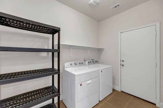 19612 Dunstan Beacon Ln, Pflugerville, TX 78660 - laundry area with washer and dryer, light tile patterned floors, and baseboards