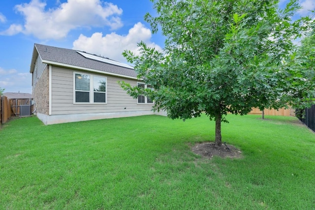 view of yard featuring a fenced backyard and central AC