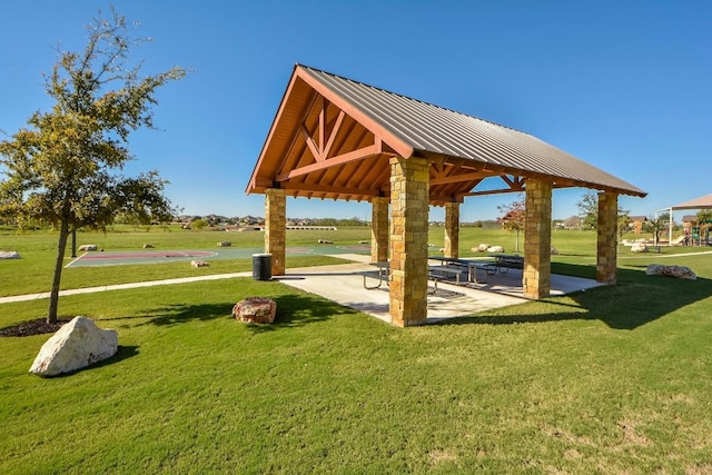 view of community featuring a gazebo, a patio, and a lawn