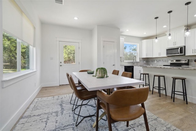 dining space featuring light wood-type flooring, visible vents, baseboards, and recessed lighting