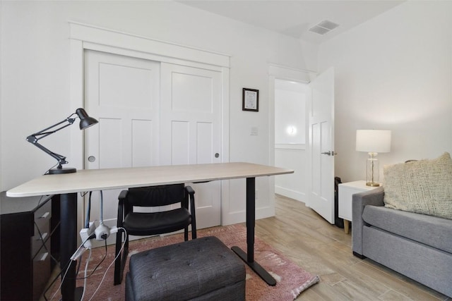 office with light wood-type flooring and visible vents