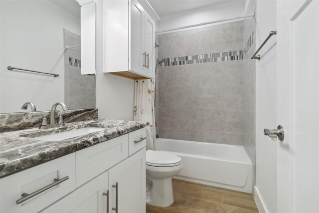 bathroom featuring shower / bath combination, vanity, and toilet