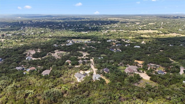 birds eye view of property featuring a forest view