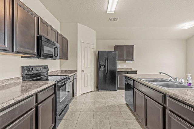 1021 Polmont Ct, Seguin, TX 78155 - kitchen with a sink, dark brown cabinets, black appliances, and visible vents