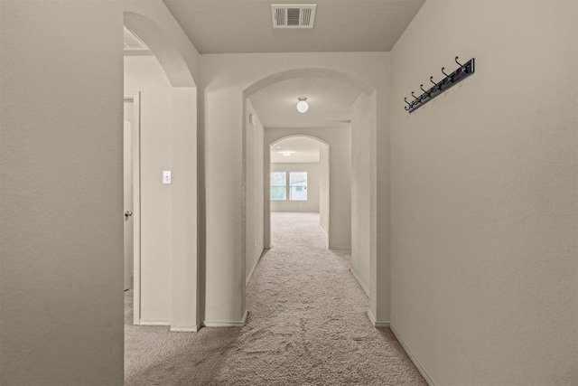 1021 Polmont Ct, Seguin, TX 78155 - hall with carpet, arched walkways, baseboards, and visible vents