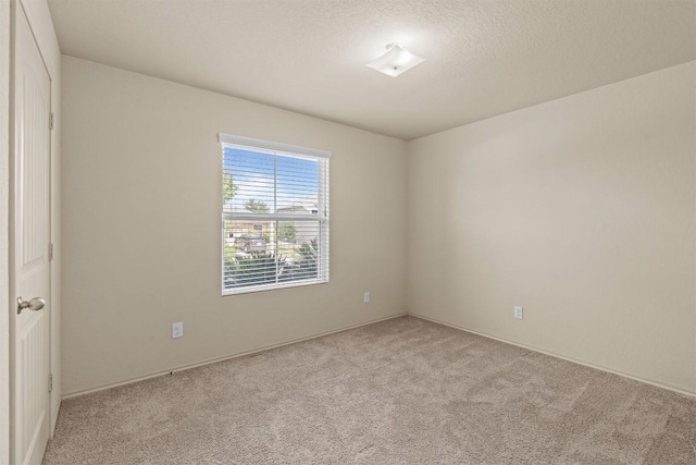 1021 Polmont Ct, Seguin, TX 78155 - spare room featuring a textured ceiling, light carpet, and baseboards