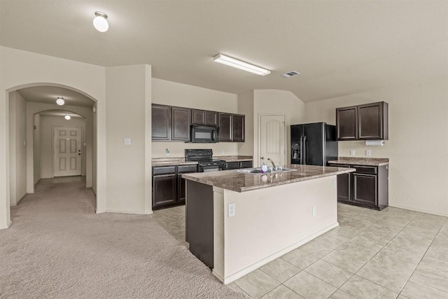 1021 Polmont Ct, Seguin, TX 78155 - kitchen featuring visible vents, a sink, dark brown cabinetry, arched walkways, and black appliances