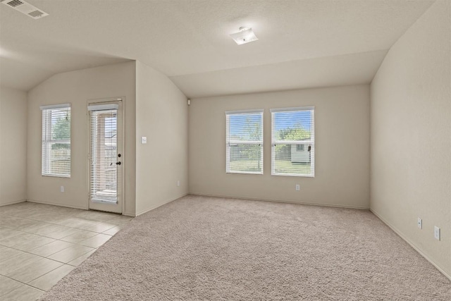 1021 Polmont Ct, Seguin, TX 78155 - unfurnished room featuring light colored carpet, visible vents, light tile patterned flooring, and lofted ceiling