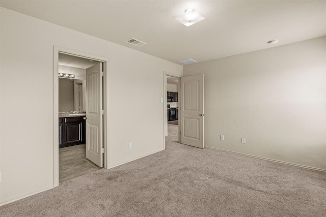 1021 Polmont Ct, Seguin, TX 78155 - unfurnished bedroom featuring ensuite bathroom, light carpet, baseboards, and visible vents
