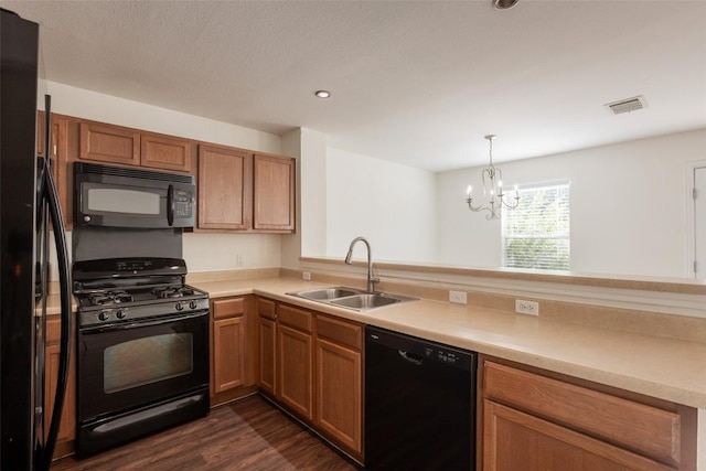 kitchen featuring a sink, visible vents, black appliances, light countertops, and a chandelier