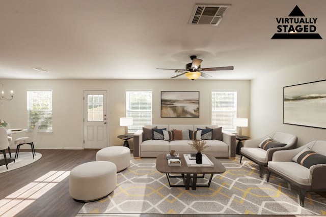 287 Quarter Ave, Buda, TX 78610 - living area featuring a chandelier, wood finished floors, a ceiling fan, and baseboards