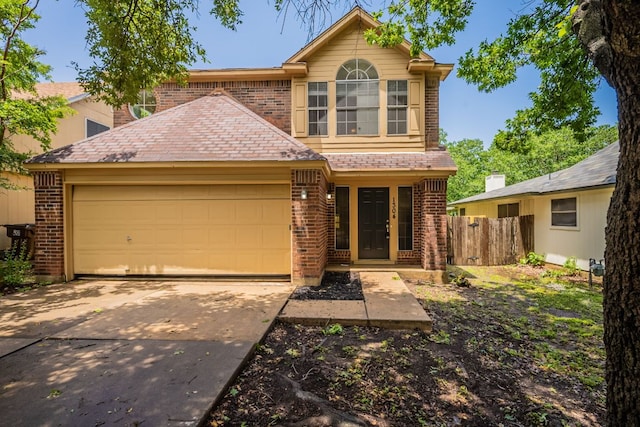 1304 Green Terrace Dr, Round Rock, TX 78664 - traditional-style home with brick siding, fence, a garage, and concrete driveway