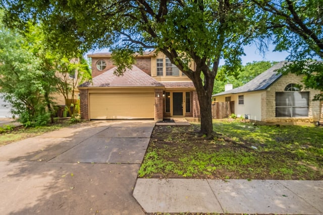 1304 Green Terrace Dr, Round Rock, TX 78664 - traditional home with driveway, brick siding, an attached garage, and fence