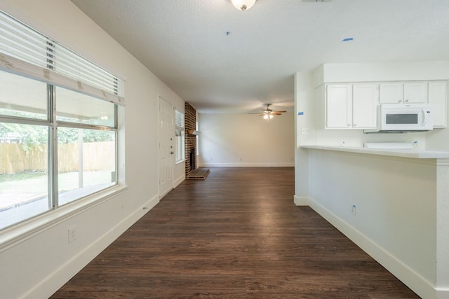 1304 Green Terrace Dr, Round Rock, TX 78664 - unfurnished living room featuring a ceiling fan, dark wood-type flooring, and baseboards