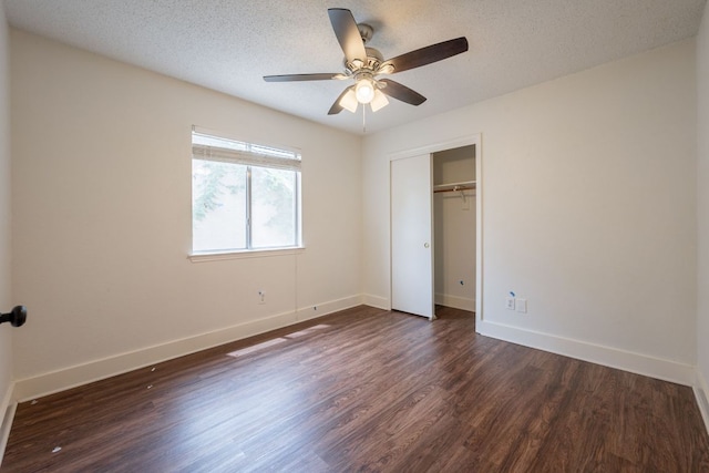 1304 Green Terrace Dr, Round Rock, TX 78664 - unfurnished bedroom featuring dark wood-style flooring, baseboards, a closet, ceiling fan, and a textured ceiling