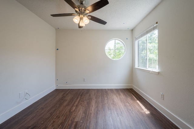 1304 Green Terrace Dr, Round Rock, TX 78664 - spare room with dark wood finished floors, baseboards, ceiling fan, and a textured ceiling