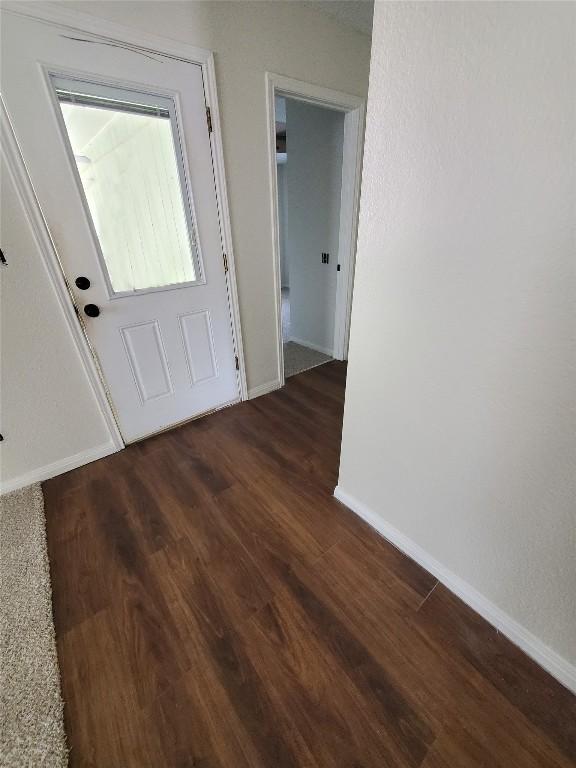 entryway with wood finished floors and baseboards