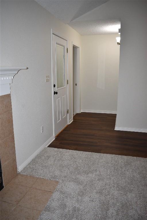 1007 N Bishop St, San Marcos, TX 78666 - hallway featuring baseboards, carpet floors, and wood finished floors