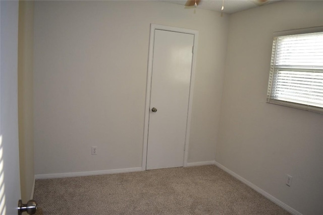 1007 N Bishop St, San Marcos, TX 78666 - unfurnished room featuring carpet flooring, a ceiling fan, and baseboards
