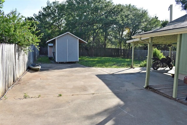 1007 N Bishop St, San Marcos, TX 78666 - view of patio with a storage unit and an outdoor structure
