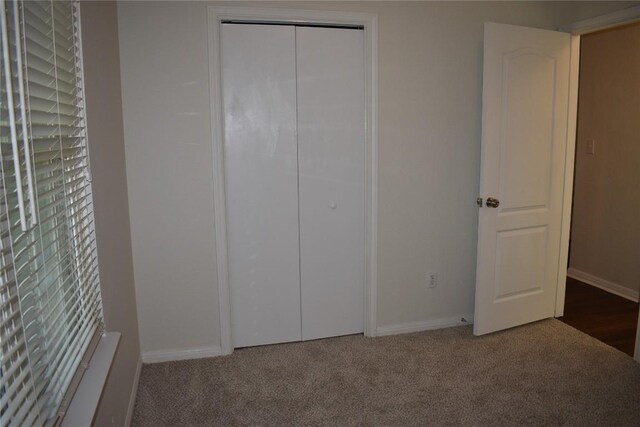 1007 N Bishop St, San Marcos, TX 78666 - unfurnished bedroom with carpet, baseboards, and a closet