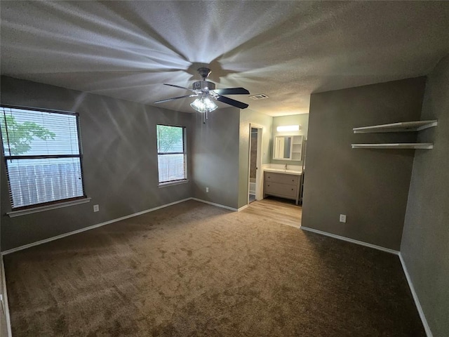 4402 Keota Dr, Austin, TX 78749 - unfurnished bedroom featuring connected bathroom, carpet floors, a textured ceiling, visible vents, and baseboards
