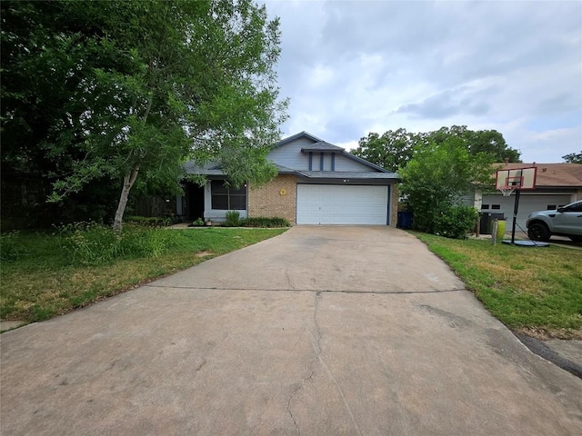 4402 Keota Dr, Austin, TX 78749 - view of front of home with an attached garage, a front yard, brick siding, and driveway