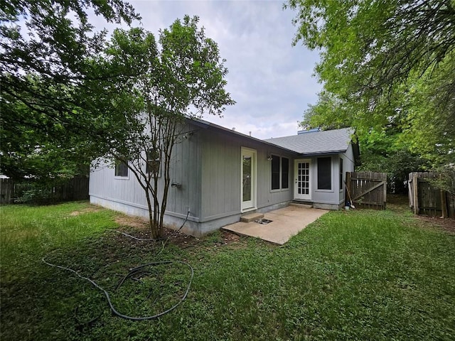 4402 Keota Dr, Austin, TX 78749 - rear view of house featuring a fenced backyard, a patio, a shingled roof, and a lawn