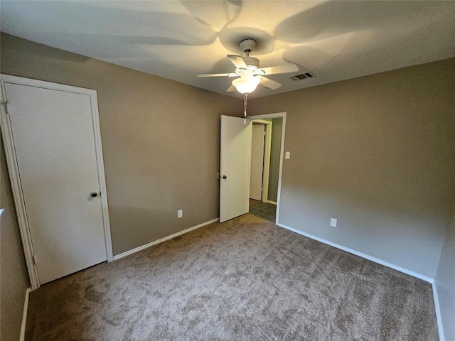 4402 Keota Dr, Austin, TX 78749 - unfurnished bedroom with baseboards, a ceiling fan, visible vents, and carpet
