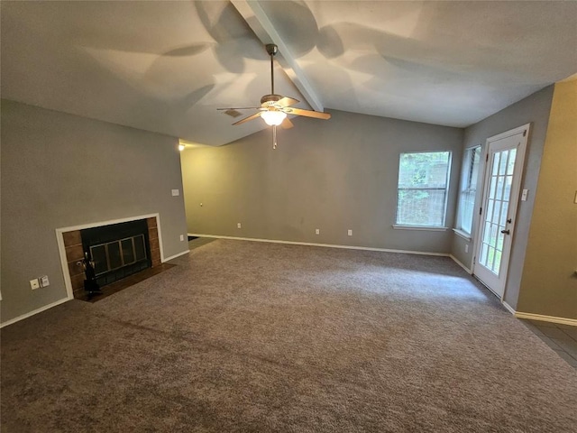 4402 Keota Dr, Austin, TX 78749 - unfurnished living room featuring a tile fireplace, vaulted ceiling with beams, baseboards, ceiling fan, and dark colored carpet