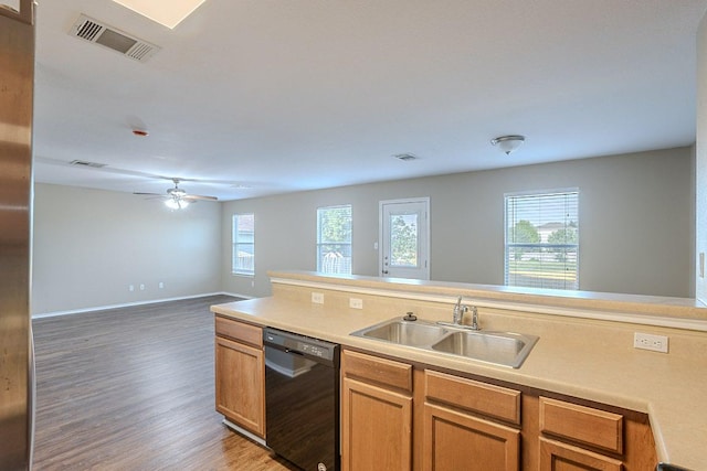 kitchen with a sink, visible vents, dishwasher, light wood finished floors, and a wealth of natural light