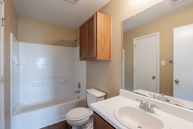 bathroom featuring vanity, toilet, tub / shower combination, and wood finished floors