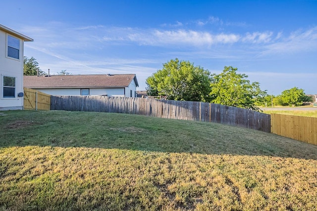 view of yard with a fenced backyard