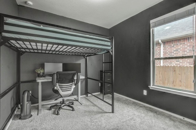 carpeted bedroom with baseboards