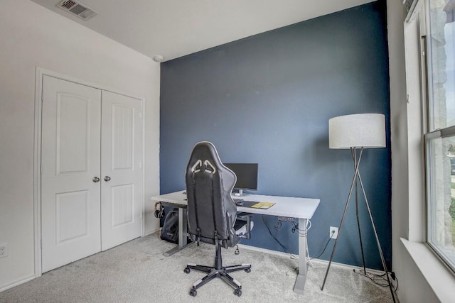 office space with carpet floors, baseboards, and visible vents