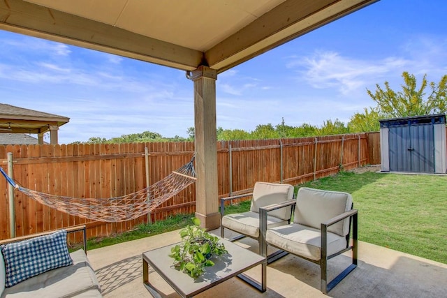 view of patio / terrace with a fenced backyard, an outdoor structure, and a shed