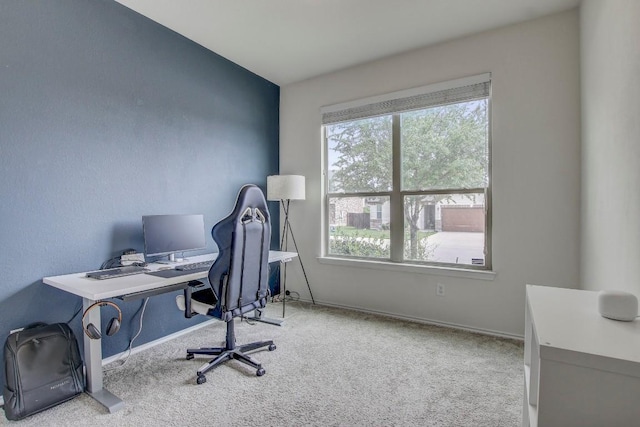 carpeted home office featuring baseboards