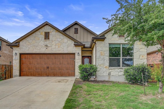 view of front of house with concrete driveway, board and batten siding, stone siding, and a garage