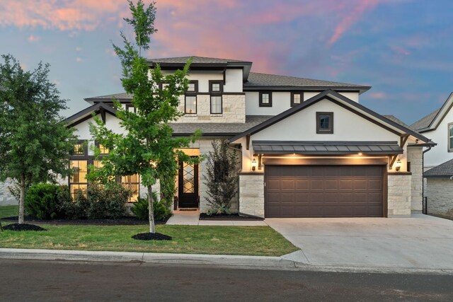 view of front of house featuring stone siding, stucco siding, a shingled roof, and driveway