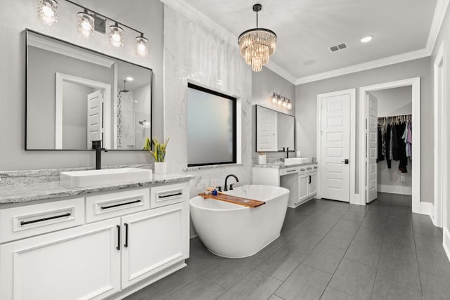bathroom featuring ornamental molding, an inviting chandelier, visible vents, a sink, and two vanities