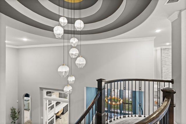 interior space with recessed lighting, ornamental molding, visible vents, and a high ceiling