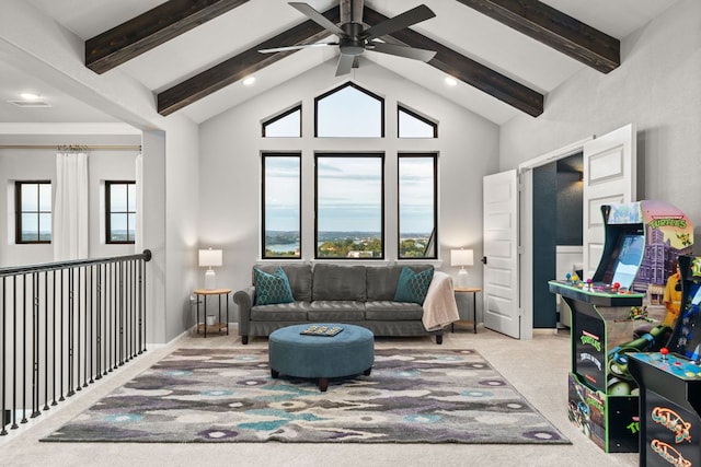 living room featuring a ceiling fan, a wealth of natural light, beam ceiling, and high vaulted ceiling