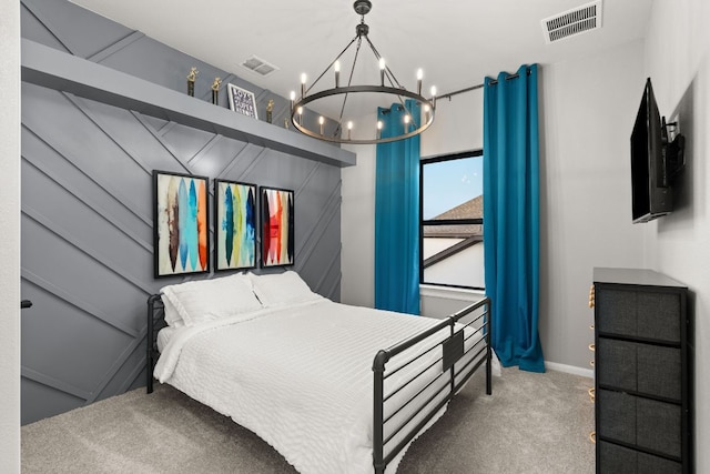 carpeted bedroom with baseboards, an inviting chandelier, and visible vents
