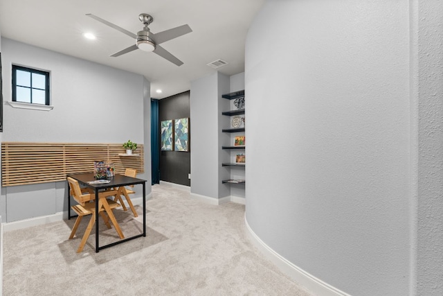 carpeted office with visible vents, baseboards, ceiling fan, built in shelves, and recessed lighting