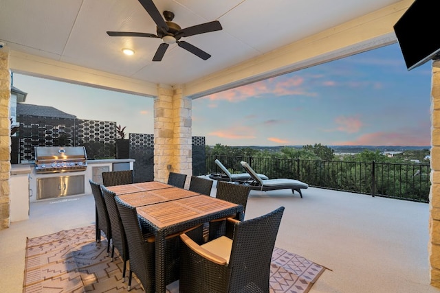 view of patio with area for grilling, outdoor dining area, a ceiling fan, and grilling area
