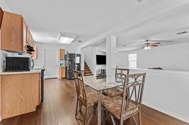 dining space with baseboards, dark wood-style flooring, visible vents, and ceiling fan