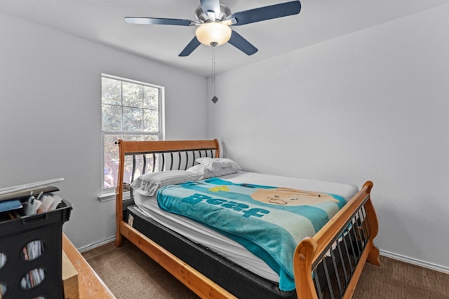 bedroom with ceiling fan, carpet, and baseboards